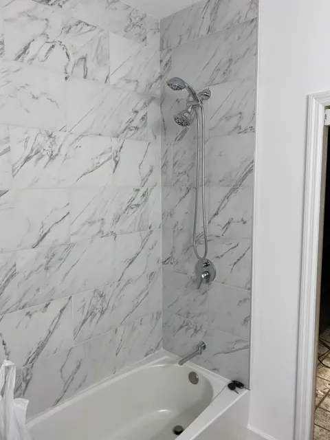 Marble tub-shower combo with dual shower head