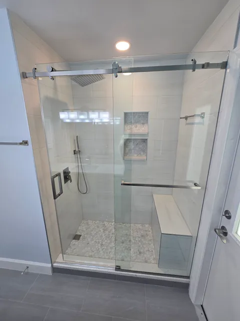 Hall bath with walk-in shower, glass door and vanity