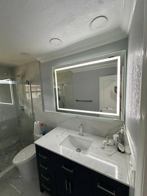 Master bath with double vanity and glass shower